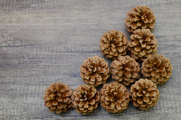 A set of pinecones on wooden, top down
