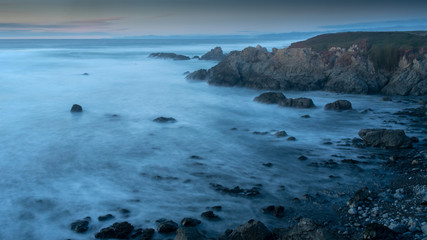 Long exposure of glass beach area in Mendocino, Fort Bragg, California, USA, featuring blue hues and a peaceful scene