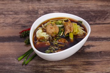 Thai style soup with meat and mushrooms