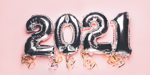 Balloon Bunting for celebration of New Year 2021 made from Silver Number Balloons on pink background. Holiday Party Decoration or postcard concept, banner size