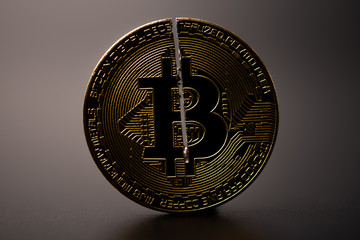 Cryptocurrency bitcoin with cutting traces on black background. sign of bitcoin halving that gennerate half of the  bitcoin from computer computing process