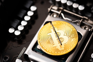 Cryptocurrency bitcoin with cutting traces in the middle on computer mainboard. sign of bitcoin...