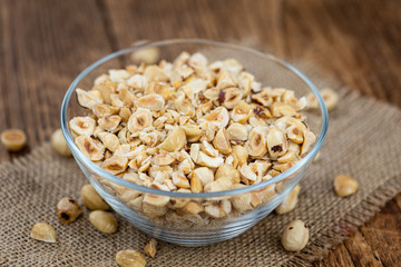 Portion of freshly chopped Hazelnuts (close up; selective focus)
