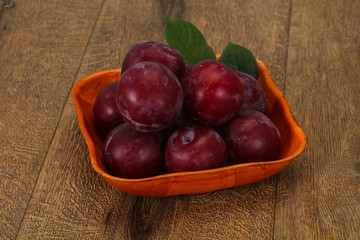 Plum heap in the wooden basket