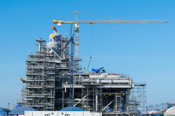 Construction Industry oil rig refinery working site with blue sky background