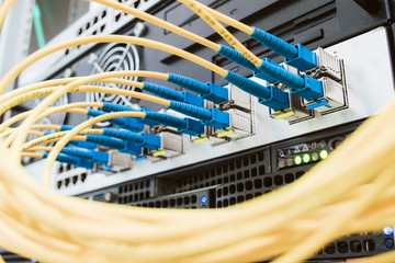 Yellow telecommunications cable in the server room of the data center. Concept of fast broadband...
