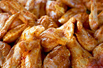 Chicken wings in a marinade. Close-up photo. Cooking chicken with spices in the oven. Grilled chicken wings recipe.