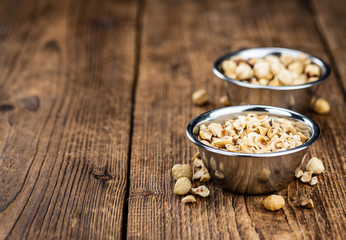 Portion of freshly chopped Hazelnuts (close up; selective focus)
