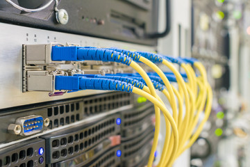 Communication equipment in the server room of the data center. Many fiber patch cords are connected to the interfaces of the Central Internet router. High-speed data transfer in a fiber-optic network