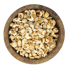 Freshly chopped Hazelnuts isolated on white background (close up; selective focus)