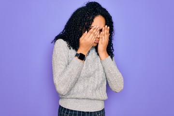 Young african american woman wearing casual sweater and glasses over purple background rubbing eyes for fatigue and headache, sleepy and tired expression. Vision problem