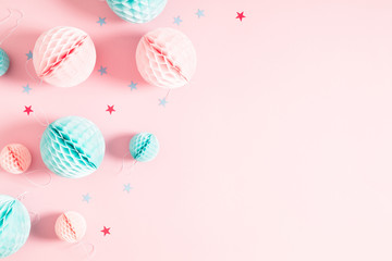 Festive pink background with confetti, paper decoration. Holiday concept on pastel pink background. Birthday, wedding, party. Flat lay, top view, copy space