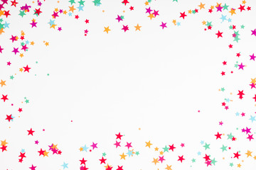 Festive white background with confetti. Holiday concept on white background. Birthday, wedding, party. Flat lay, top view, copy space