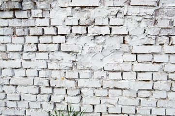 Beautiful white painted brick wall shabby old with cracks in the loft style with seams. Texture, background