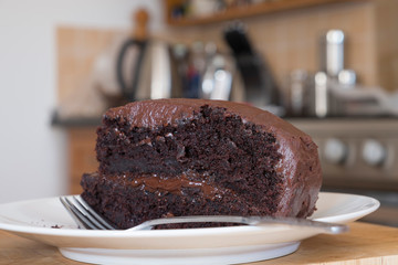 slice of rich moist chocolate cake on a plate