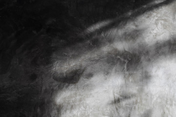 The polished cement wall background shines with sunlight.