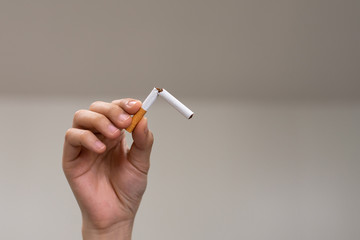 Hands holding and breaking the cigarette for quit smoking. Stop smoking cigaratte for health concept.