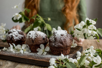 Delicious chocolate cupcakes on a wooden table