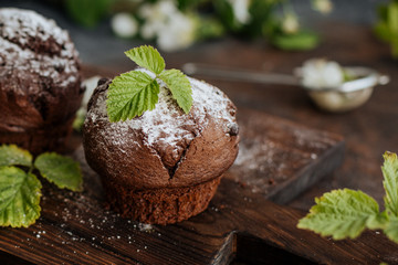Delicious chocolate cupcakes on a wooden table