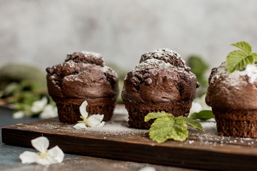 Delicious chocolate cupcakes on a wooden table