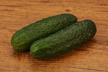 Green fresh cucumbers over background