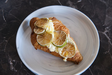 croissant with creme patisserie and lemon
