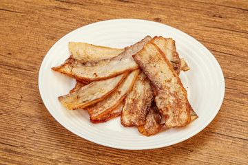 Roasted juicy bacon in the plate