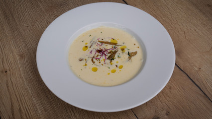 Spicy thick creamy broccoli cheese soup in a bowl with toast close-up on the table. horizontal