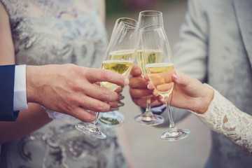 hands holding glass of champagne