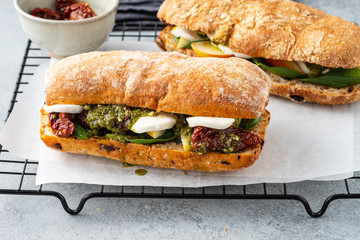 Fresh whole grain bun with tomato, pesto and mozarella. Copy space.