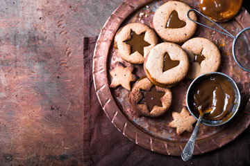 Homemade Christmas New year star shape  caramel cookies  over wooden  background. Flat lay, space.