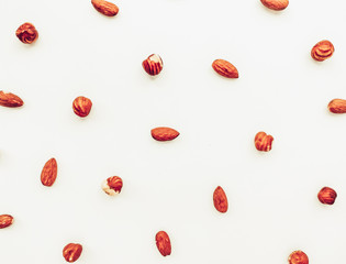 Almonds and hazelnuts on a white background