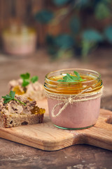 Fresh homemade chicken liver pate on bread over rustic background