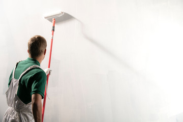 Male decorator painting a wall