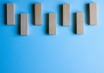 Wooden cubes in a row. They are isolated on a blue background.