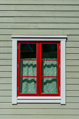 Fototapeta na wymiar Soderkoping, Sweden A finely painted window and facade of a wooden house.