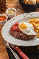 Argentine style meat cut with egg and fried potatoes 