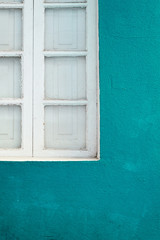 White window in blue facade