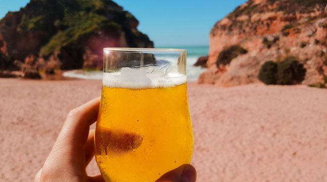 Glass Of Cold Beer On Beach