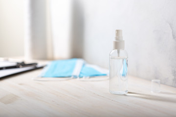 Hand disinfection spray. Sanitizer hand protection. Medical masks, paper towel roll and clipboard.