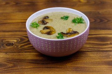 Mushroom cream soup on a wooden table