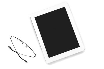 Tablet computer and eyeglasses isolated on white background. Top view, flat lay