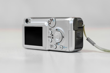 Old digital camera. The small camera is silver.