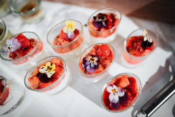 photo of a strawberry dessert in cups with flowers