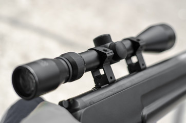 Optical sight of a sniper rifle close-up. Black optical sight.