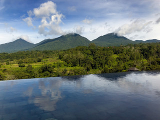 View of the tropical nature and mountains and the pool in the foreground. Baturiti Tabanan, Bali..