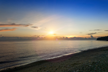 Bali. Amed. Sunrise over the black sand beach.