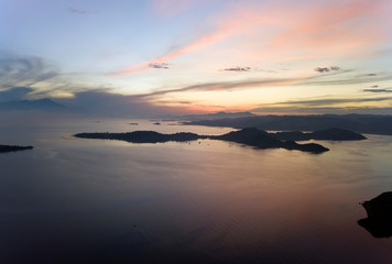 Naklejka premium Lombok, Indonesia, south Gili islands. Aerial drone view on silhouette of hills Gili Gide island in the sea at sunset..