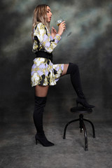 Beautiful, glamourous caucasian blonde girl posing in studio on isolated background. Style, trends,...