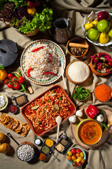 cooked and uncooked haricot beans, served with traditional cooked rice and Traditional red lentil soup. Table garnished with legumes, vegetables and seasonings. Rich cuisine, delicious food.